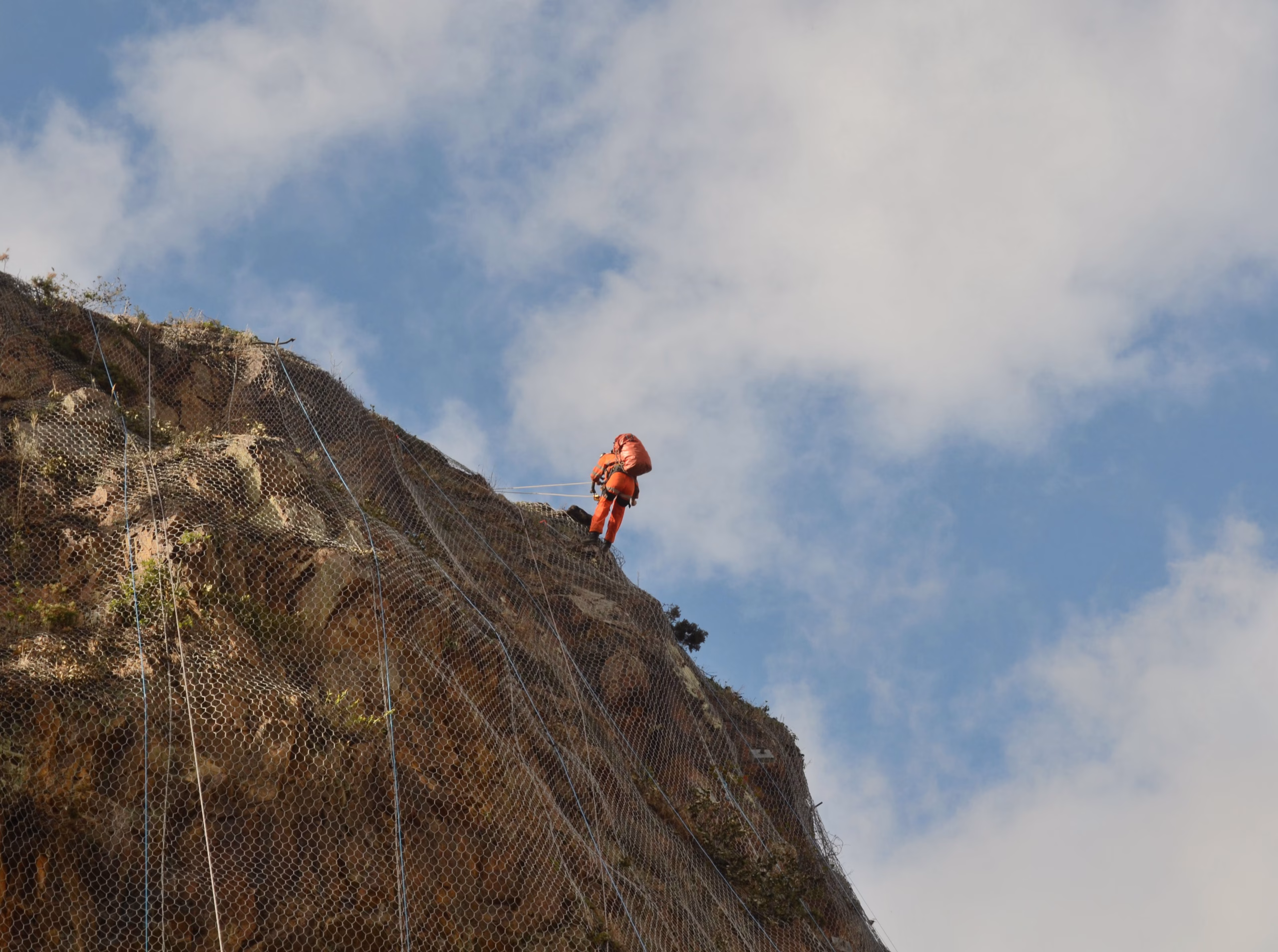 CAN team member working on a rock face