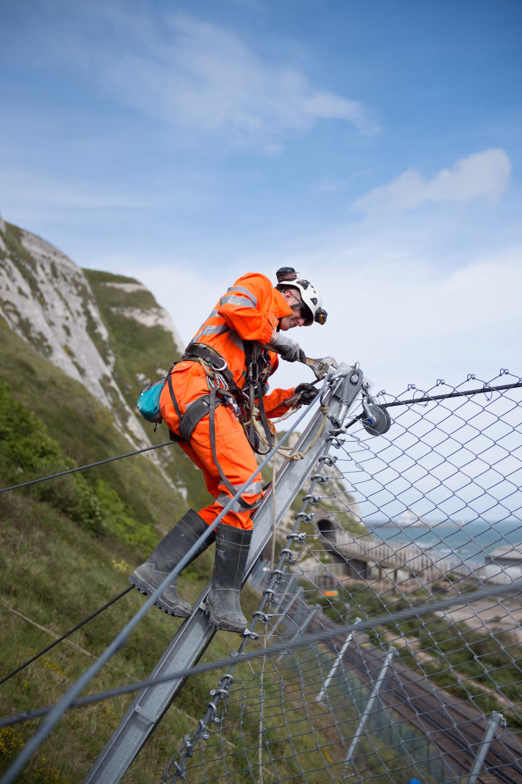 Worker installing a catch fence.