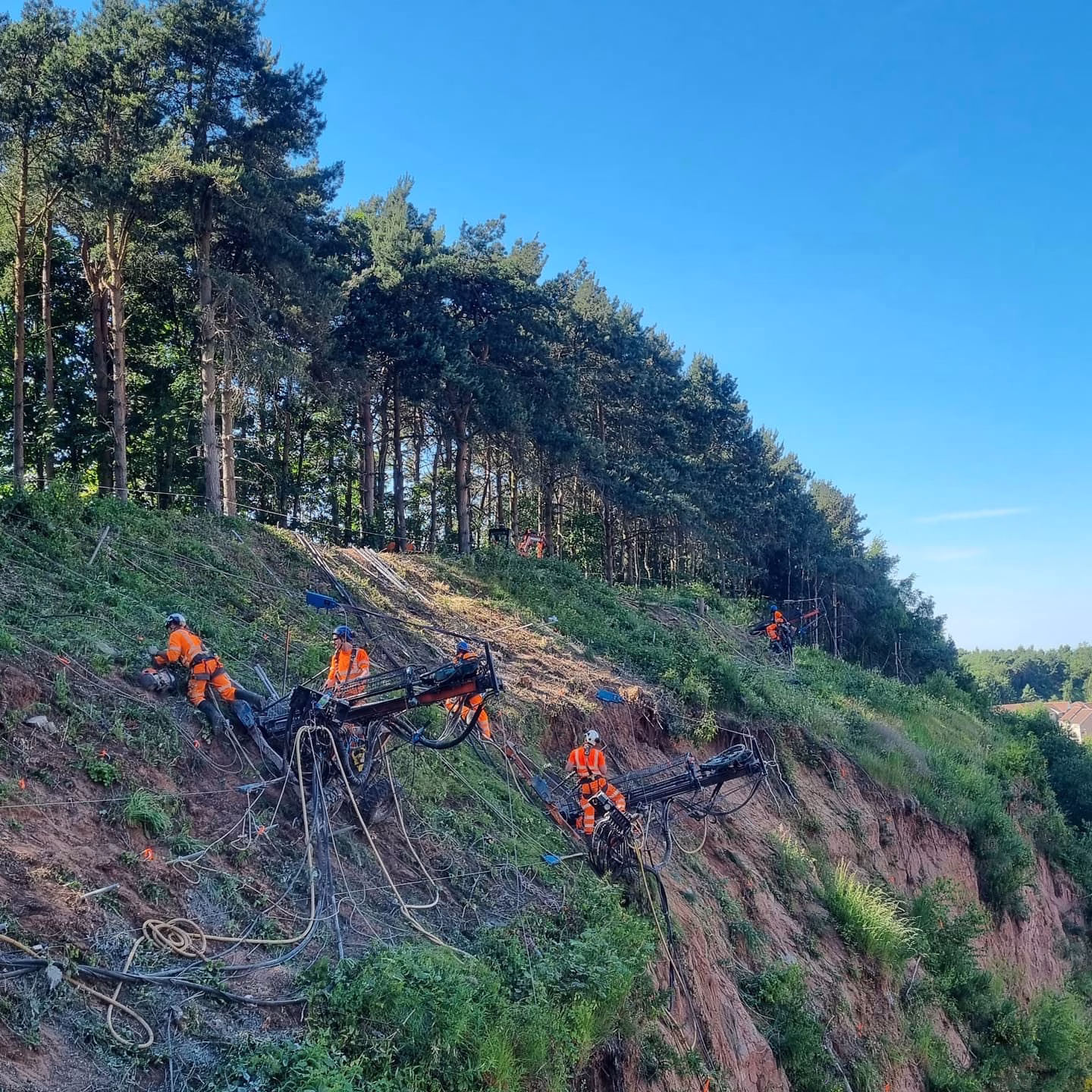 Workers performing soil nailing