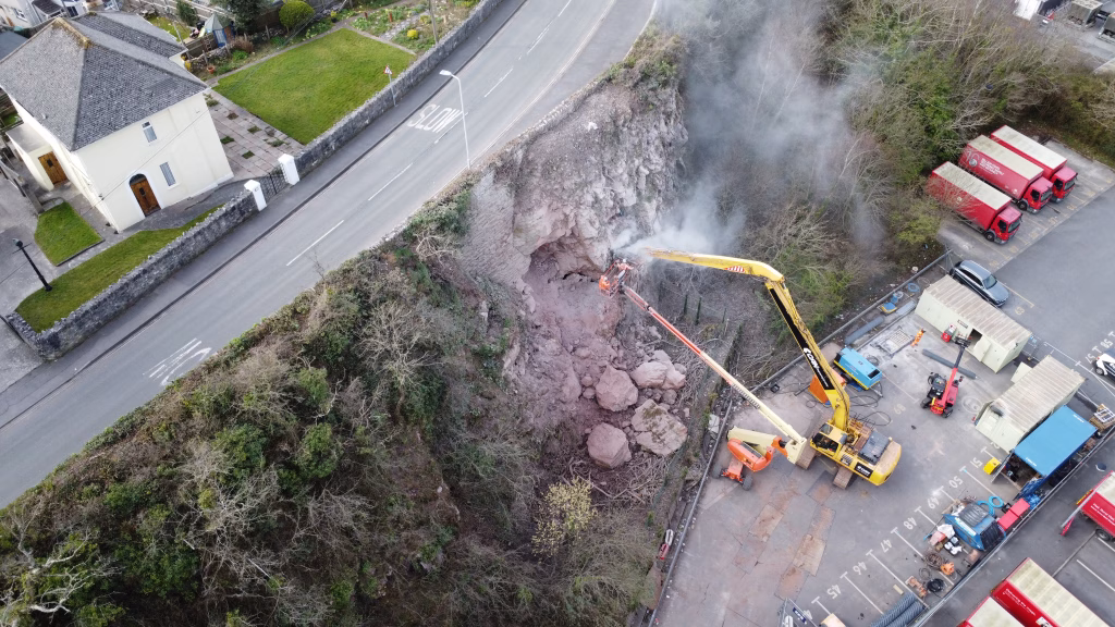 CAN team members removing a rock that may endanger a industrial facility.