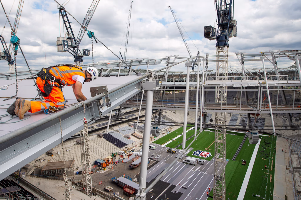 Worker on a stadium roof