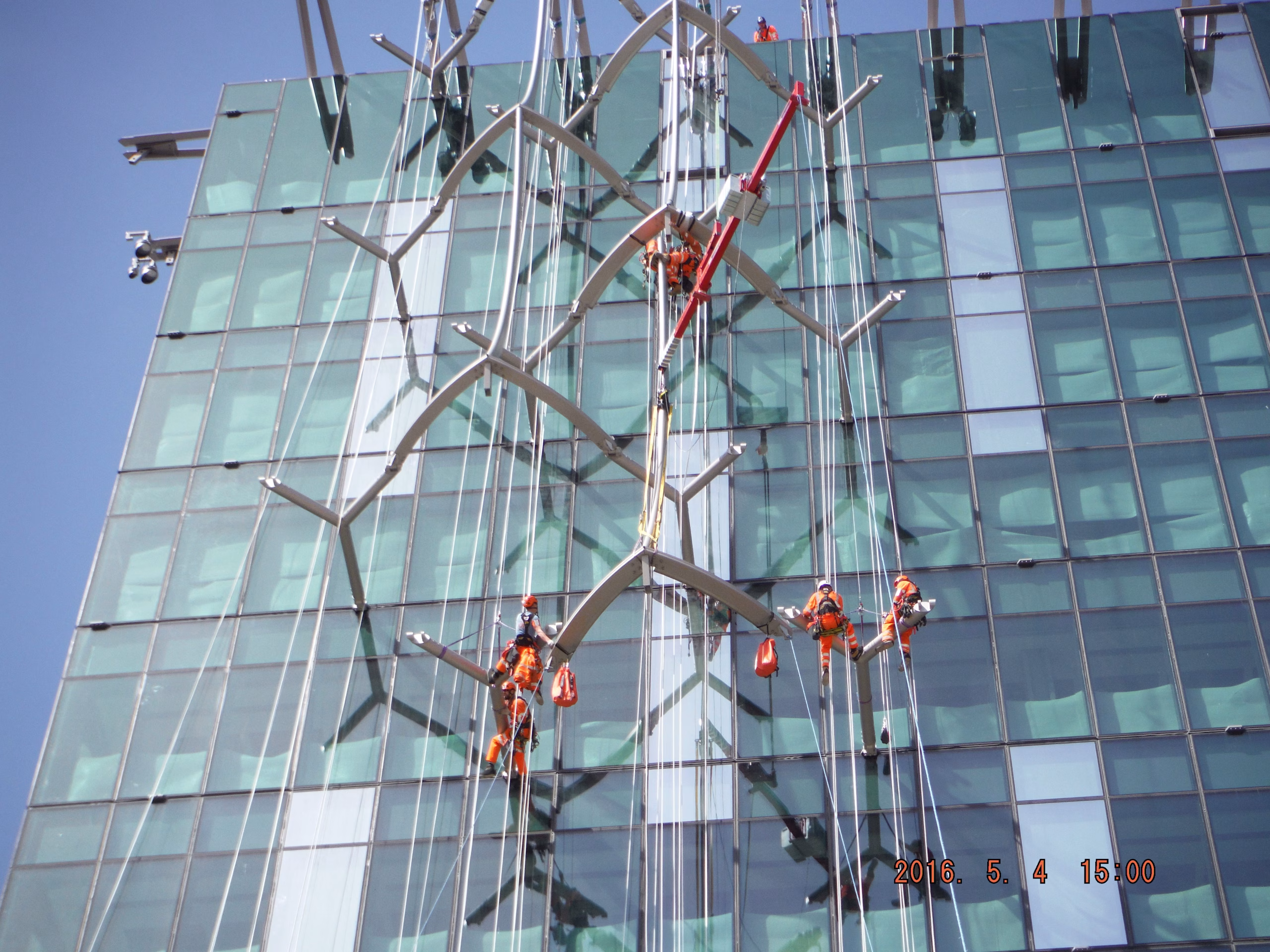 CAN workers on the side of a sky scraper.
