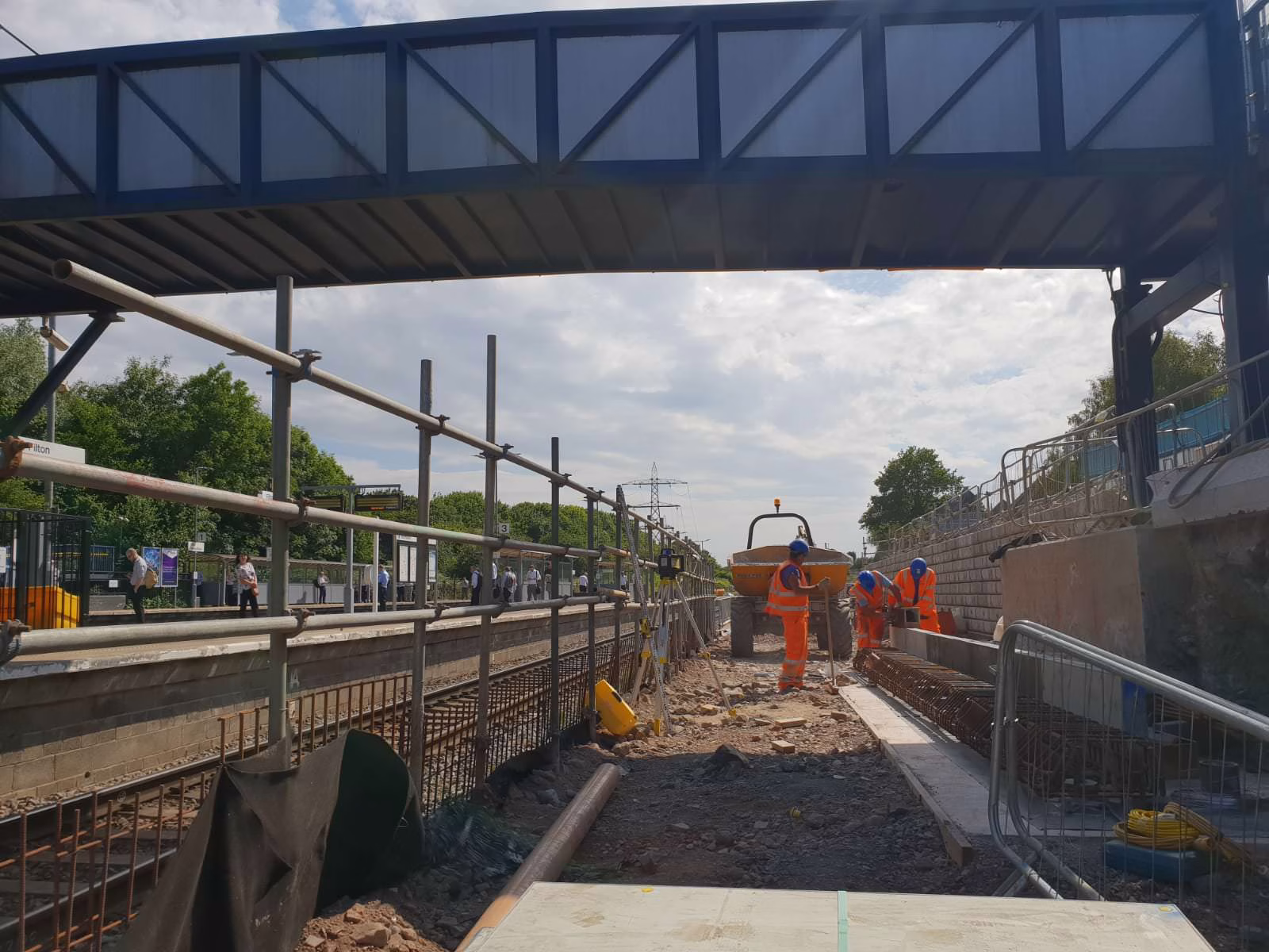 Team members working under a bridge.